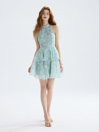 Emerald ruffle mini dress with shirred shoulders and flared hem, ideal for romantic vacation looks