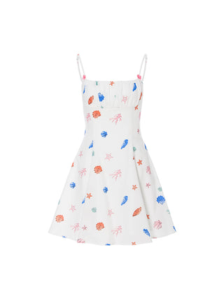 Mini dress with seashell neckline and ruffle details, ideal for vacation or resort styling