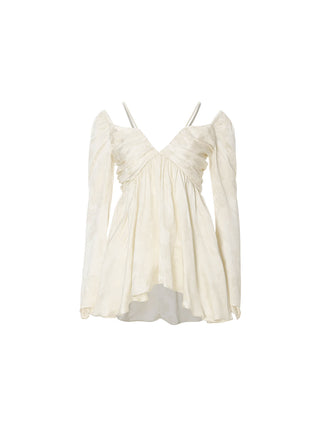 Model wearing the Opaline Jacquard Flare Blouse, a floral jacquard off-shoulder top with adjustable straps, flared hem and long bell sleeves for an elegant dressed-up look – SINCETHEN. 