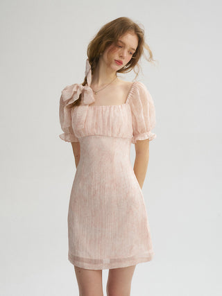 Model wearing the Peony Square Neck Mini Dress in a romantic floral pattern with lace detail, perfect for spring dates.