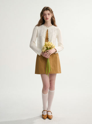 Woman wearing a white pointelle ribbon knit cardigan – soft, romantic, and ideal for spring.