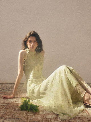 Sage Halterneck Long Dress — front view showing halterneck, ruffle trim, and rosette accent