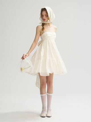 Model wearing the Saint Back Ribbon Mini Dress with a square neckline, elegant silhouette, and romantic back ribbon – ideal for self-weddings and lovely bridal moments.