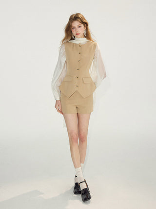 Woman wearing minimal sandstone shorts with a matching vest for a polished look