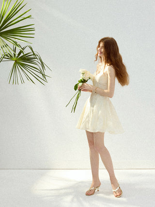 White mini dress with eyelet embroidery and puff sleeves, perfect for a lovely and feminine look