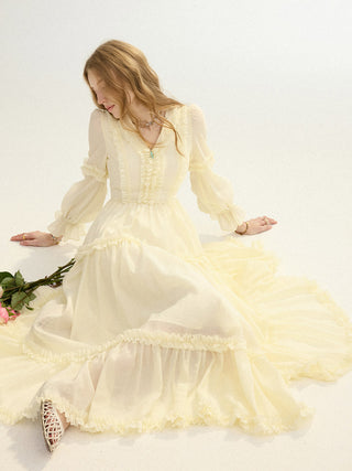 A woman wearing the SINCETHEN Solea Frill Maxi Dress, showcasing the romantic ruffle details and flowy silhouette.