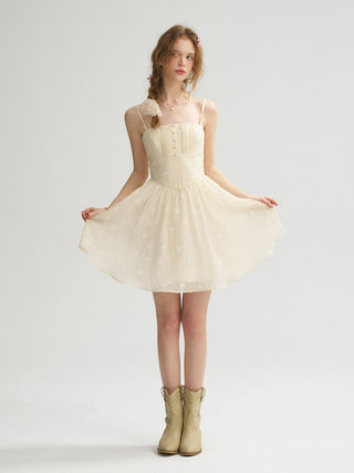 Model wearing the Waltz Pintuck Mini Dress with soft pintuck detailing, ribbon accents, and a lovely feminine fit.